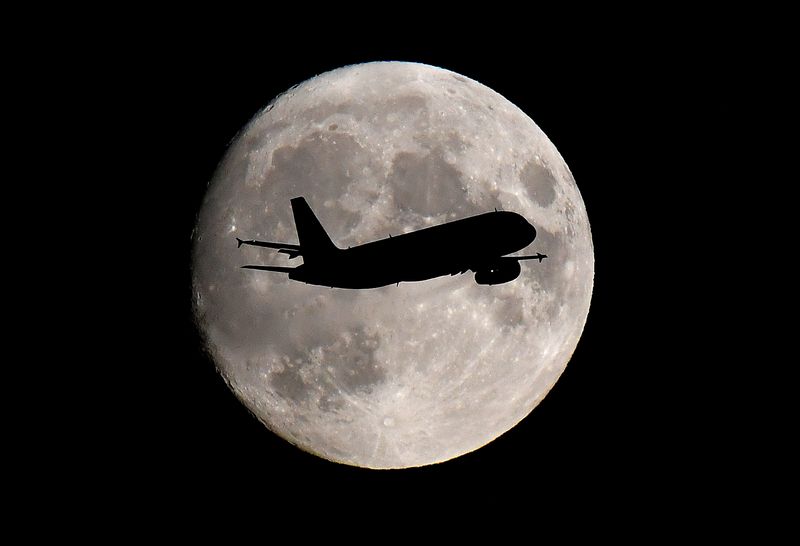 &copy; Reuters. FILE PHOTO: A passenger plane passes in front of the moon as it makes its final landing approach to Heathrow Airport in London, Britain September 12, 2019. REUTERS/Toby Melville/File Photo
