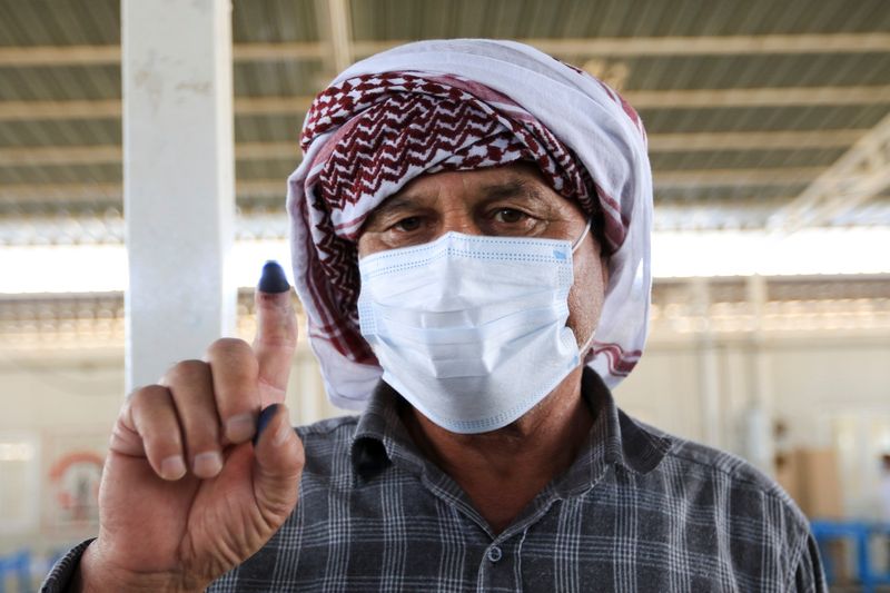 &copy; Reuters. A displaced Yazidi man shows his inked finger as he casts his vote at a polling station, two days ahead of Iraq's parliamentary elections in a special process, at the Sharya camp, in Duhok, Iraq October 8, 2021. REUTERS/Ari Jalal
