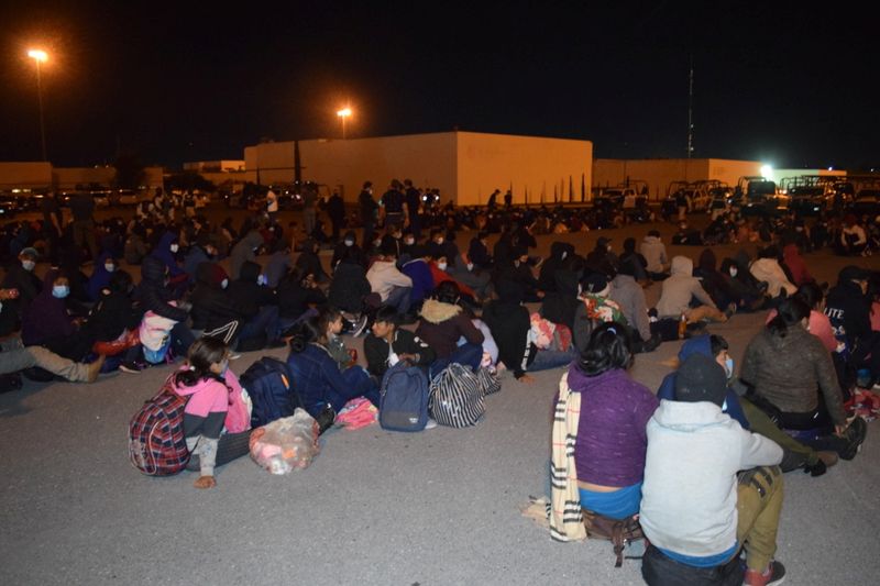 &copy; Reuters. Migrants sit in a complex field of Public Security after hundreds of Central Americans packed into three long cargo trucks headed to the United States were detained in northern Mexico late Thursday in, according to police, one of the biggest such round-up