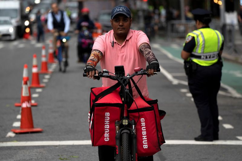 &copy; Reuters. FILE PHOTO: A delivery worker is pictured on the street in New York City, New York, U.S., September 23, 2021.  REUTERS/David 'Dee' Delgado/File Photo