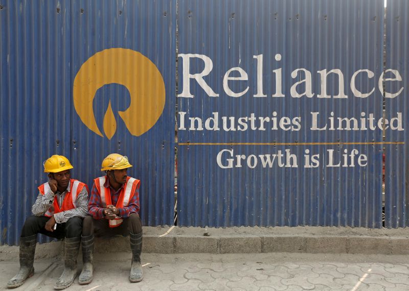 &copy; Reuters. FILE PHOTO: Labourers rest in front of an advertisement of Reliance Industries Limited at a construction site in Mumbai, India, March 2, 2016. REUTERS/Shailesh Andrade/File Photo