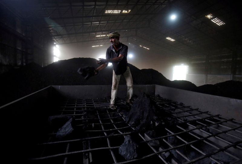 &copy; Reuters. FILE PHOTO: A labourer works inside a coal yard on the outskirts of Ahmedabad, India, April 6, 2017. REUTERS/Amit Dave//File Photo