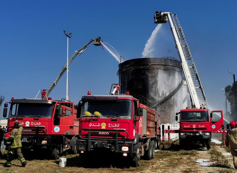 © Reuters. Fire engines are pictured after firefighters put out a blaze that raged at a gasoline storage tank at the Zahrani oil facility in southern Lebanon, October 11, 2021. REUTERS/Ali Hankir NO RESALES. NO ARCHIVES.