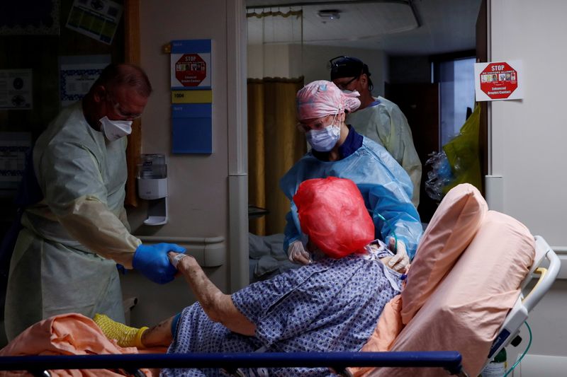 &copy; Reuters. FILE PHOTO: Members of a COVID medical team transport a coronavirus disease (COVID-19) positive patient to their room on the COVID medical unit at Sarasota Memorial Hospital in Sarasota, Florida, U.S., September 21, 2021. REUTERS/Shannon Stapleton/File Ph