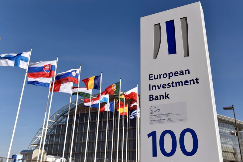 &copy; Reuters. FILE PHOTO: Flags are seen behind the logo of the European Investment Bank pictured in the city of Luxembourg, Luxembourg, March 25, 2017. Reuters/Eric Vidal/File Photo