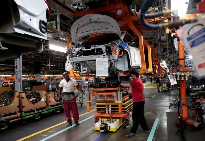 &copy; Reuters. FILE PHOTO: General Motors assembly workers connect a battery pack underneath a partially assembled 2018 Chevrolet Bolt EV vehicle on the assembly line at Orion Assembly in Lake Orion, Michigan, U.S., March 19, 2018.   REUTERS/Rebecca Cook/File Photo