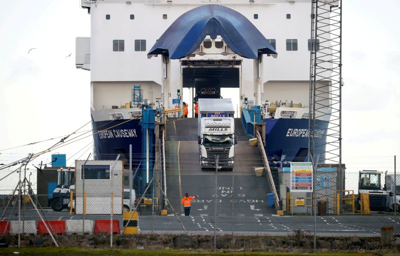 © Reuters. FILE PHOTO: Lorries leave a ferry at the Port of Larne, Northern Ireland Britain January 1, 2021. REUTERS/Phil Noble/File Photo