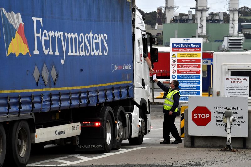 &copy; Reuters. A worker at the Port of Larne customs post checks paperwork from a lorry driver before allowing him to board a ferry bound for the UK, in Larne, Northern Ireland, October 13, 2021. REUTERS/Clodagh Kilcoyne