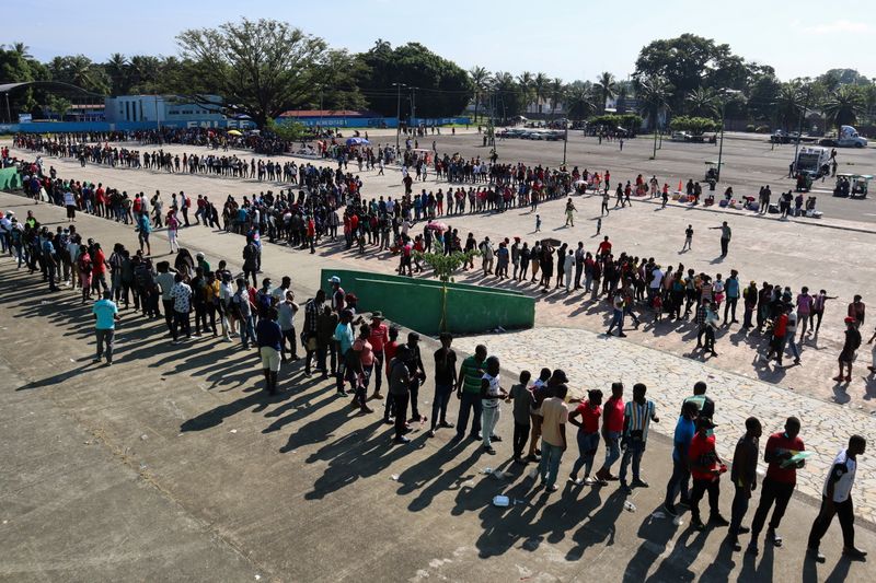&copy; Reuters. Migrants, mostly Haitians, wait for asylum processing by Mexico's Commission for Refugee Assistance (COMAR) outside a soccer stadium, in Tapachula, Mexico October 12, 2021. REUTERS/Jose Torres