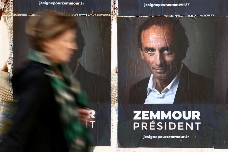 &copy; Reuters. A woman walks past posters in support of French far-right commentator Eric Zemmour, probable candidate for the French presidential election next April, posted on a wall in Paris, France, October 13, 2021. The slogan reads "Zemmour President". REUTERS/Sara