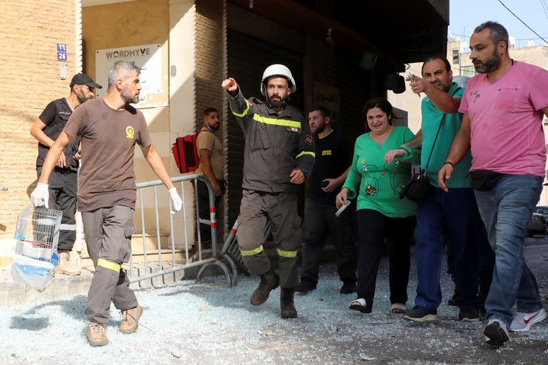 &copy; Reuters. منقذون يساعدون في إجلاء الناس بعد إطلاق النار في بيروت يوم الخميس. تصوير: محمد عزاقير - رويترز