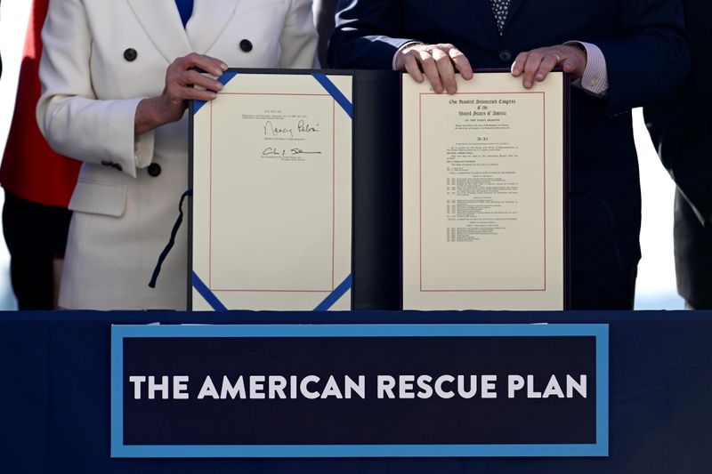 &copy; Reuters. FILE PHOTO: House Speaker Nancy Pelosi (D-CA) and Senate Majority Leader Chuck Schumer display the "American Rescue Plan" during the enrolment ceremony following passage of U.S. President Joe Biden's $1.9 trillion coronavirus disease (COVID-19) relief bil