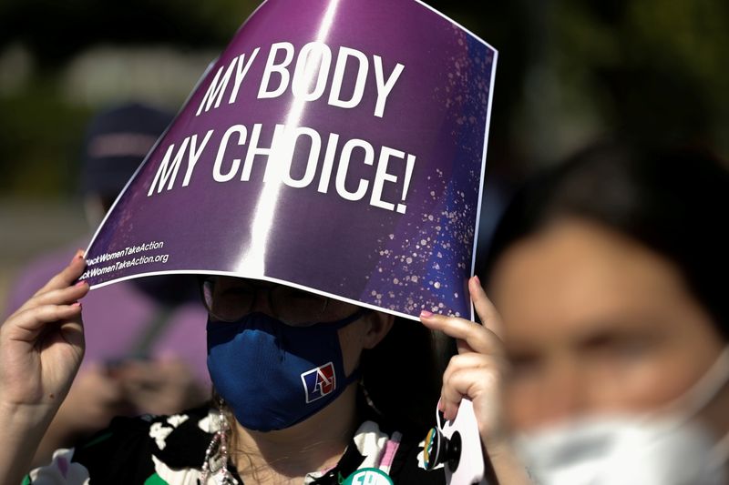 &copy; Reuters. FILE PHOTO: A demonstrator holds a pro-abortion rights sign as she listens to speakers at a Black Women Take Action event outside the U.S. Supreme Court building in Washington, U.S. September 15, 2021.  REUTERS/Jonathan Ernst/File Photo