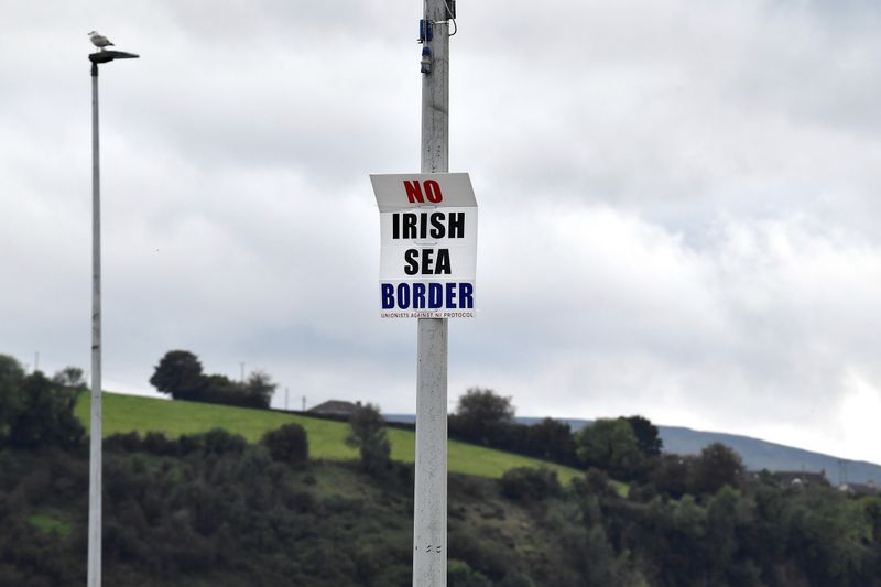 &copy; Reuters. FILE PHOTO: A sign reading 'No Irish Sea border' is seen affixed to a lamp post at the Port of Larne, Northern Ireland, October 13, 2021. REUTERS/Clodagh Kilcoyne