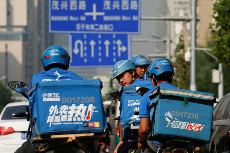 &copy; Reuters. FILE PHOTO: Drivers of the food delivery service Ele.me prepare to start their morning shift in Beijing, China, September 21, 2017. REUTERS/Thomas Peter/File Photo