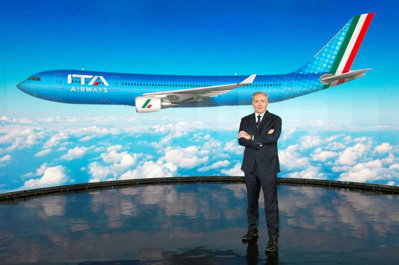 © Reuters. ITA Airways Chairman Alfredo Altavilla poses with the image of the new livery for the carrier's jets, in Italy, October 15, 2021. ITA Press Office/Handout via REUTERS  