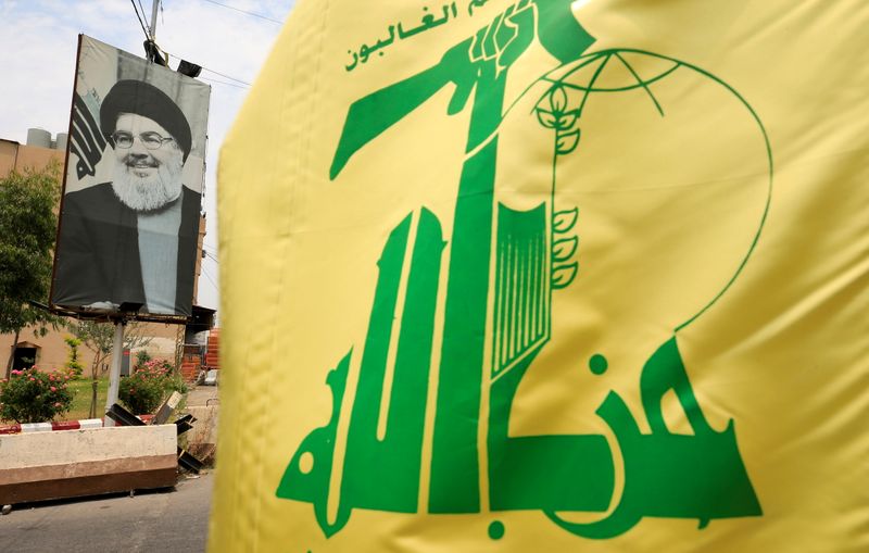 &copy; Reuters. FILE PHOTO: A Hezbollah flag and a poster depicting Lebanon's Hezbollah leader Sayyed Hassan Nasrallah are pictured along a street, near Sidon, Lebanon July 7, 2020. REUTERS/Ali Hashisho