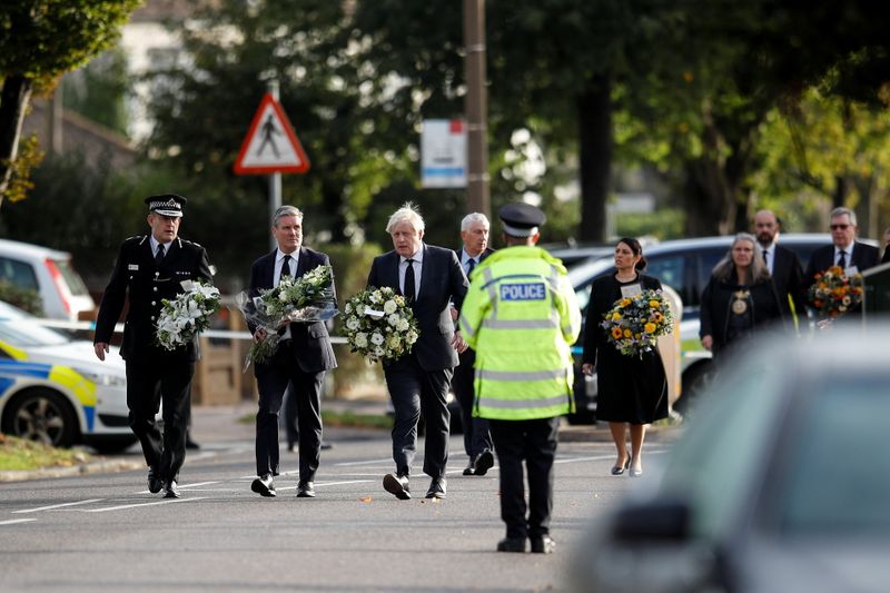 &copy; Reuters. Britain's Labour Party leader Keir Starmer, Prime Minister Boris Johnson and Home Secretary Priti Patel hold flowers as they arrive at the scene where British MP David Amess was stabbed to death during a meeting with constituents at the Belfairs Methodist