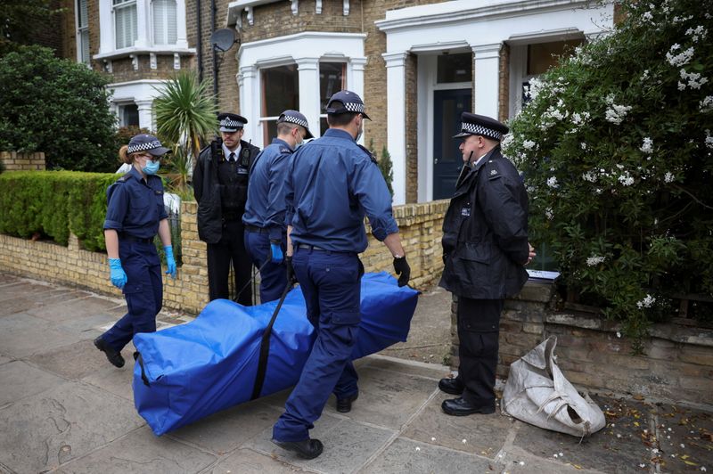 &copy; Reuters. Police officers carry equipment into the front garden of a house believed to be an address belonging to a man arrested in connection with the killing of British MP David Amess, who was stabbed to death during a meeting with constituents, in London, Britai