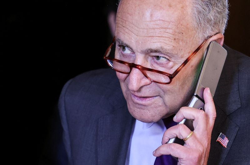 &copy; Reuters. FILE PHOTO: U.S. Senate Majority Leader Chuck Schumer (D-NY) talks on a phone as he departs following the weekly Senate Democratic policy lunch at the U.S. Capitol in Washington, U.S., September 14, 2021. REUTERS/Evelyn Hockstein