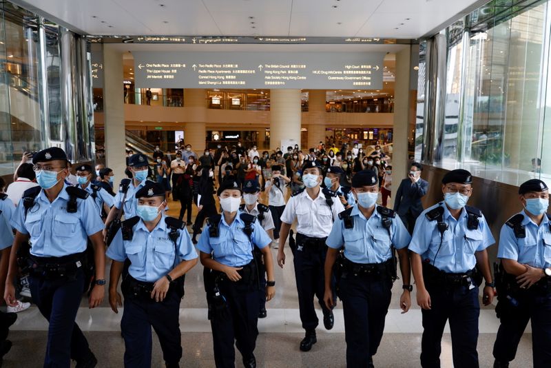 &copy; Reuters. FILE PHOTO: Police ask supporters to leave during the court hearing of Tong Ying-kit, the first person charged under a new national security law near the High Court, in Hong Kong, China. July 30, 2021. REUTERS/Tyrone Siu/File Photo