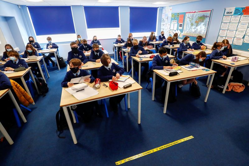 &copy; Reuters. FILE PHOTO: Students attend a lesson at Weaverham High School, as the coronavirus disease (COVID-19) lockdown begins to ease, in Cheshire, England, March 9, 2021. REUTERS/Jason Cairnduff
