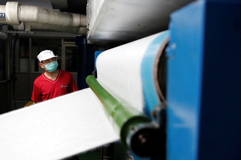&copy; Reuters. FILE PHOTO: Staff member works inside a non woven filter fabric factory, where the fabric is used to make surgical face masks, in Taoyuan, Taiwan, March 30, 2020. REUTERS/Ann Wang