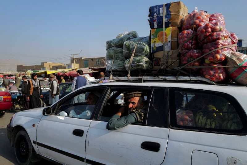 &copy; Reuters. A man rides a car filled with vegetables and fruits for sale at the market in Kabul, Afghanistan October 18, 2021. REUTERS/Zohra Bensemra