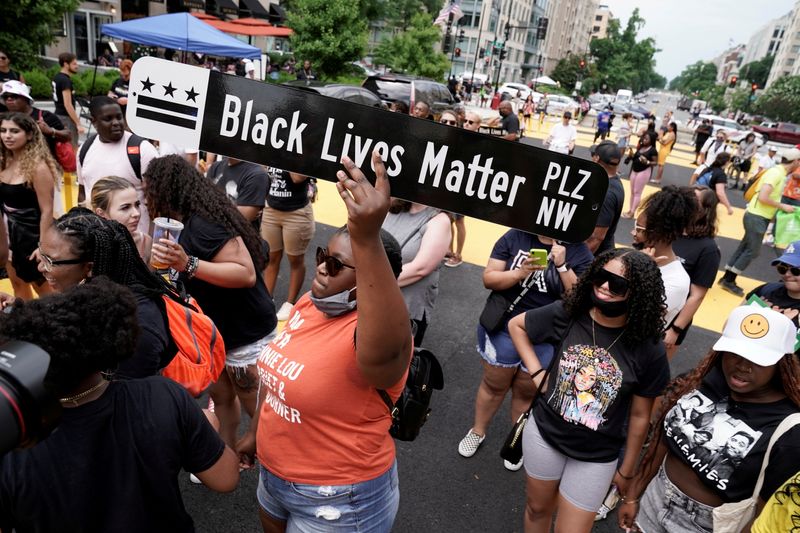 &copy; Reuters. FILE PHOTO: People celebrate Juneteenth, which commemorates the end of slavery in Texas, two years after the 1863 Emancipation Proclamation freed slaves elsewhere in the United States, at Black Lives Matter Plaza in Washington, D.C. U.S., June 19, 2021. R