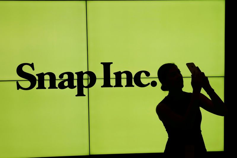 &copy; Reuters. FILE PHOTO: A woman stands in front of the logo of Snap Inc on the floor of the New York Stock Exchange (NYSE) in New York City, NY, U.S. March 2, 2017. REUTERS/Lucas Jackson