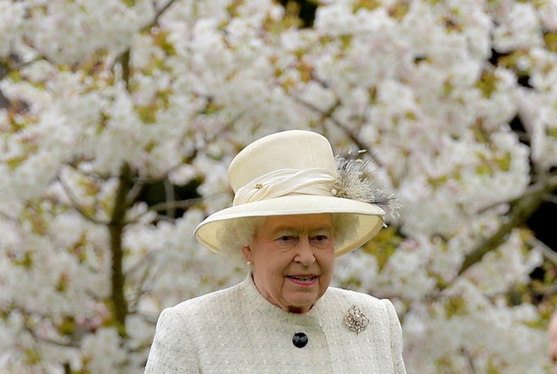 &copy; Reuters. FILE PHOTO: Britain's Queen Elizabeth walks among spring blossom and flowers as she arrives to attend the unveiling of a statue in Windsor,southern England, March 31, 2014.  REUTERS/Toby Melville/File Photo