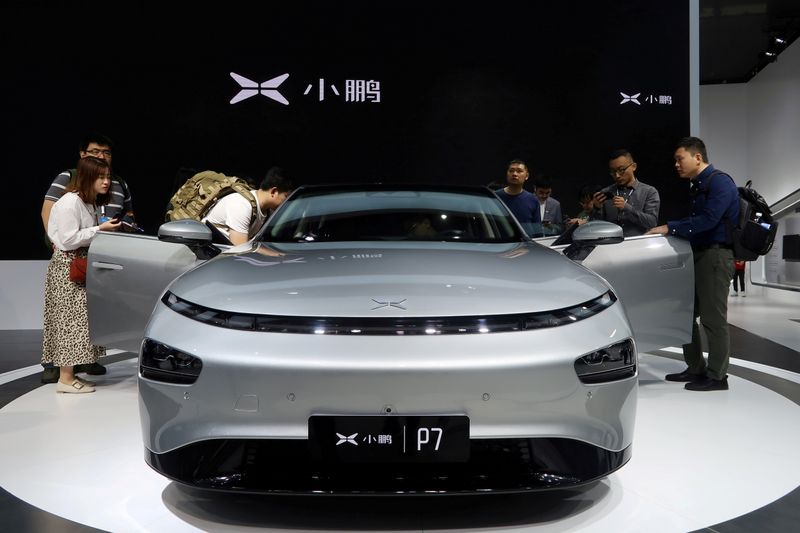 &copy; Reuters. FILE PHOTO: People look at XPeng's P7 sedan model displayed at the Guangzhou auto show in Guangzhou, Guangdong province, China November 22, 2019. REUTERS/Yilei Sun/File Photo