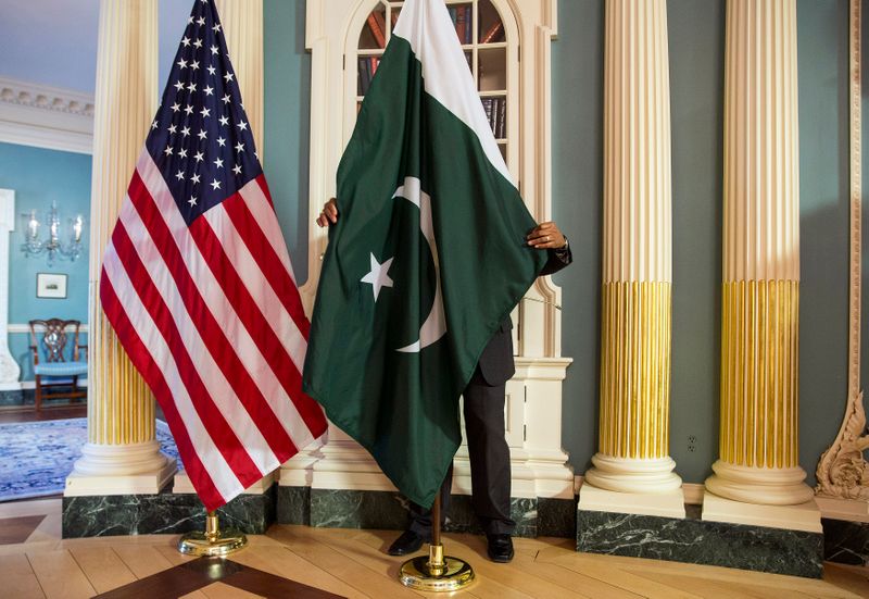 &copy; Reuters. FILE PHOTO: A State Department contractor adjust a Pakistan national flag before a meeting between U.S. Secretary of State John Kerry and Pakistan's Interior Minister Chaudhry Nisar Ali Khan on the sidelines of the White House Summit on Countering Violent