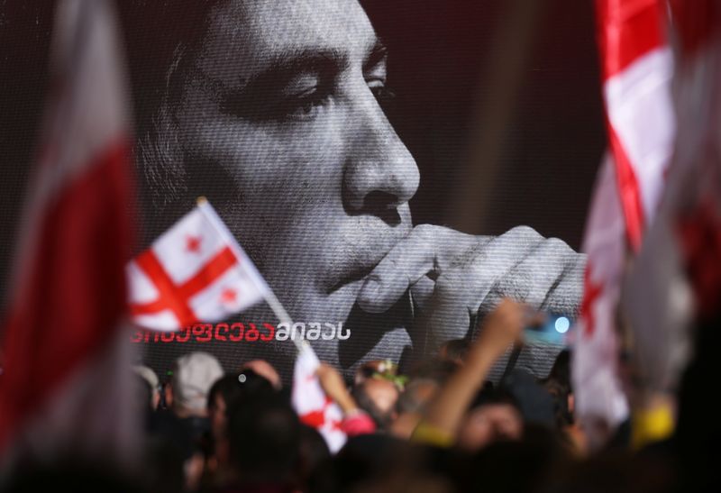 &copy; Reuters. A portrait of Georgian former President Mikheil Saakashvili is seen on a screen as people attend a rally demanding his release from jail in Tbilisi, Georgia October 14, 2021. REUTERS/Irakli Gedenidze