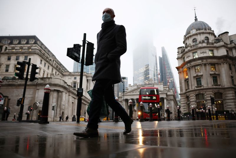 &copy; Reuters. FILE PHOTO: A man walks through the City of London financial district, amid the coronavirus disease (COVID-19) outbreak, in London, Britain, March 4, 2021.  REUTERS/Henry Nicholls