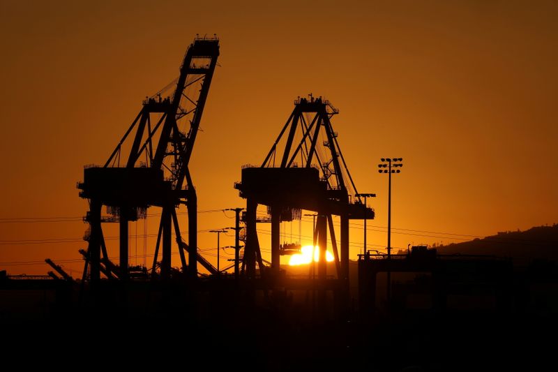&copy; Reuters. FILE PHOTO: The sun sets behind container cranes at the Port of Los Angeles in Los Angeles, California, U.S. October 14, 2021.  REUTERS/David Swanson/File Photo