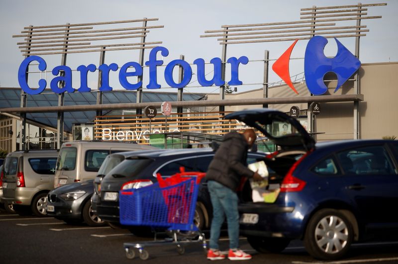 &copy; Reuters. FILE PHOTO: A customer empties his trolley in front of a Carrefour Hypermarket store in Saint-Herblain near Nantes, France January 15, 2021. REUTERS/Stephane Mahe