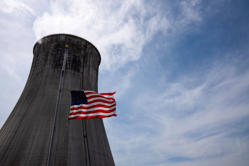 &copy; Reuters. The US flag flies at half mast in front of a coal-fired power plant's cooling tower at Duke Energy's Crystal River Energy Complex in Crystal River, Florida, U.S., March 26, 2021. Picture taken March 26, 2021. REUTERS/Dane Rhys/Files