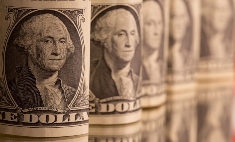 Dollar pares losses as Powell signals bond taper