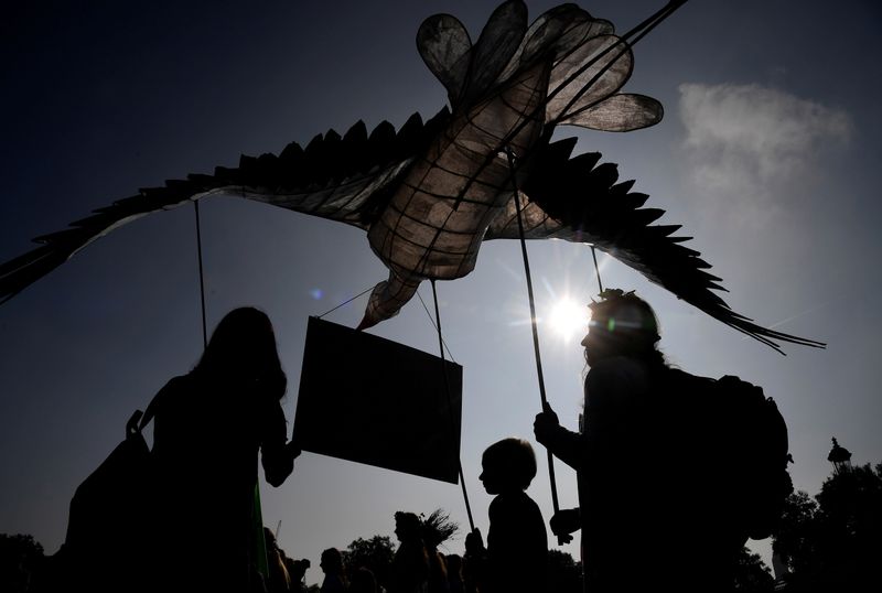 &copy; Reuters. FILE PHOTO: Environmental campaigners hold a stork puppet as they take part in a march and delivery of a petition to the Buckingham Palace, demanding that the British royal family rewild their land, ahead of the COP26 climate summit due to take place in N