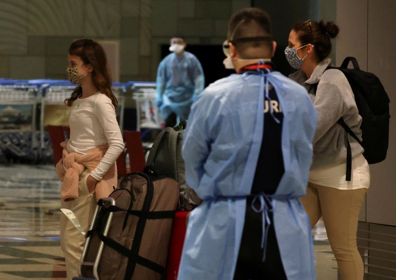 Analysis-Vaccinated Singapore shows zero-COVID countries cost of reopening