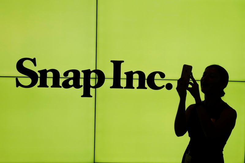 &copy; Reuters. A woman stands in front of the logo of Snap Inc. on the floor of the New York Stock Exchange (NYSE) while waiting for Snap Inc. to post their IPO, in New York City, NY, U.S. March 2, 2017. REUTERS/Lucas Jackson     TPX IMAGES OF THE DAY