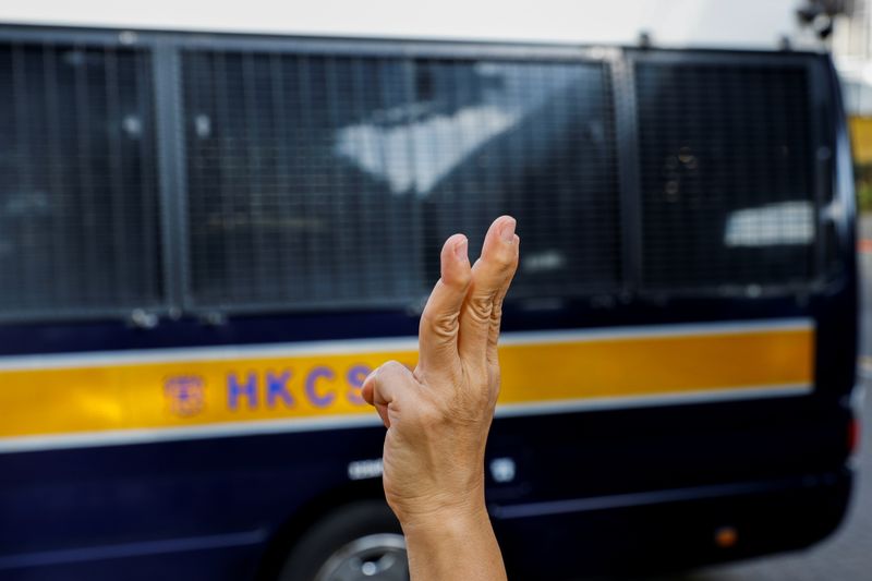 &copy; Reuters. FILE PHOTO: Pro-democracy activist Alexandra Wong greets people as a prison van arrives outside West Kowloon Magistrates' Courts building before a hearing on the Hong Kong Alliance in Support of Patriotic Democratic Movements of China, suspected of violat