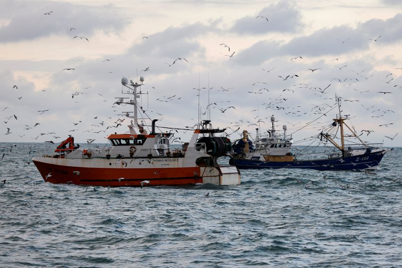 &copy; Reuters. FILE PHOTO: The French trawler "Thomas Nicolas II" sails past a Dutch trawler in the North Sea, off the coast of northern France, December 7, 2020. Picture taken with a drone December 7, 2020. REUTERS/Pascal Rossignol/File Photo