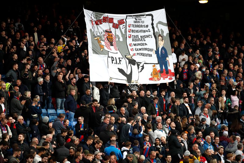 &copy; Reuters. Soccer - England - Premier League - Crystal Palace v Newcastle United - Selhurst Park, London, Britain - October 23, 2021 Crystal Palace fans with a banner about Newcastle United's takeover before the match REUTERS/Peter Nicholls 