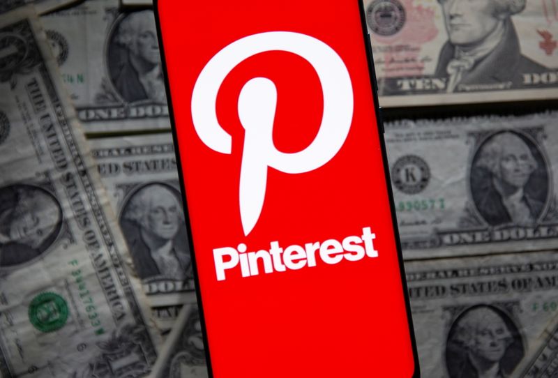 &copy; Reuters. A Pinterest logo is seen on a smartphone placed over U.S. dollar banknotes in this illustration taken October 20, 2021. REUTERS/Dado Ruvic/Illustration