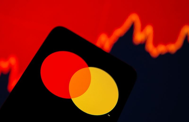 &copy; Reuters. PHILR PHOTO: Smartphone with Mastercard logo is seen in front of displayed stock graph in this illustration taken, July 15, 2021. REUTERS/Dado Ruvic/Illustration