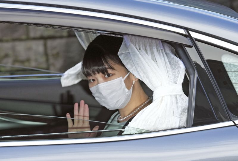 &copy; Reuters. Japan's Princess Mako waves from inside a car as she leaves her home for her marriage in Akasaka Estate in Tokyo, Japan October 26, 2021 in this photo taken by Kyodo. Kyodo/via REUTERS  