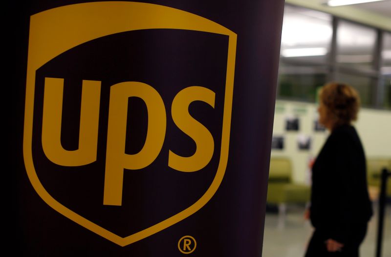 &copy; Reuters. A woman walks past a sign bearing the logo of United Parcel Service (UPS) at a job fair in Chicago, Illinois, October 18, 2014. REUTERS/Jim Young 
