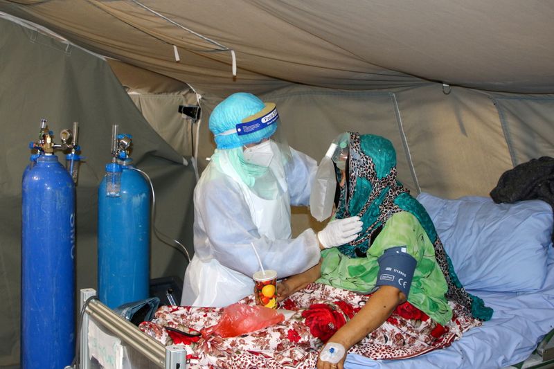 &copy; Reuters. ممرضة تباشر مريضة بكوفيد-19 في مركز لعزل المرضى في عدن في جنوب اليمن يوم 27 مارس آذار 2021. تصوير: فواز سلمان - رويترز.